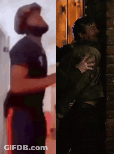 Man Hugging Man Beside Brick Wall GIF