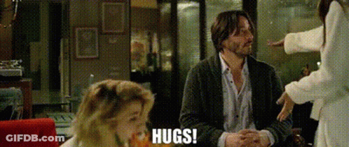 Man Hugging Woman At Table GIF