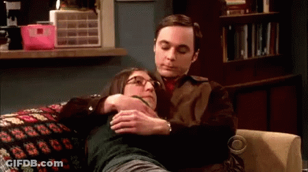 Man Hugging Woman On Couch GIF