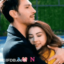 Man Hugging Woman With Initials A And N GIF
