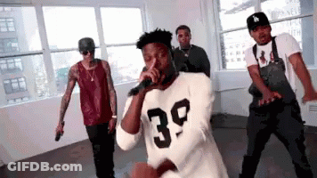 Man In 39 Shirt Singing While Men Dance GIF