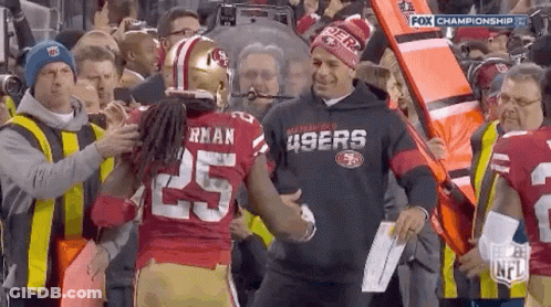 Man In 49Ers Sweatshirt Shaking Hands With Football Player GIF