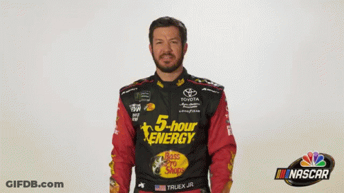Man In 5 Hour Energy Shirt In Front Of Nascar Logo GIF