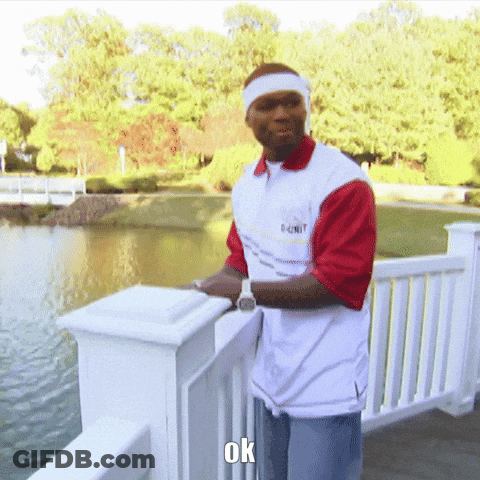 Man In 50 Cent Shirt On Railing Overlooking Lake GIF