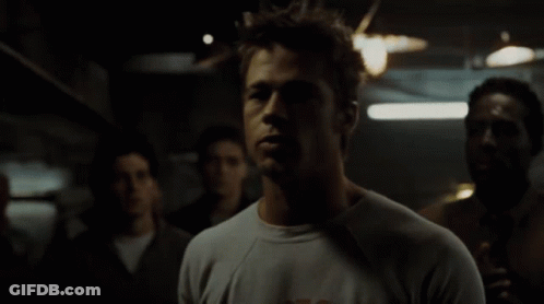 Man In A Shirt In Dark Room GIF