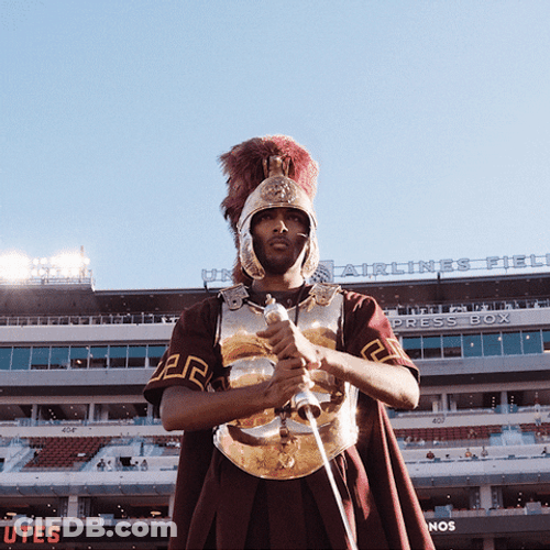 Man In A Trojans Costume Sword Attack GIF