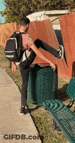 Man In Adidas Backpack Stretching Leg By Trash Can GIF
