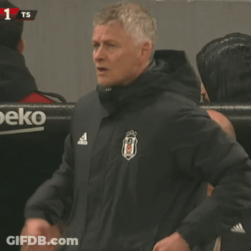 Man In Adidas Jacket In Front Of Beko Banner GIF