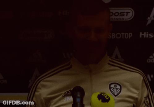 Man In Adidas Jacket In Front Of Boost Drinks Sign GIF