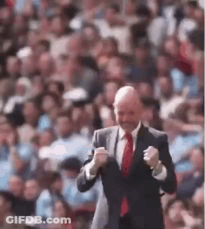 Man In Adidas Shirt Smiling In Front Of Emirates Ads GIF