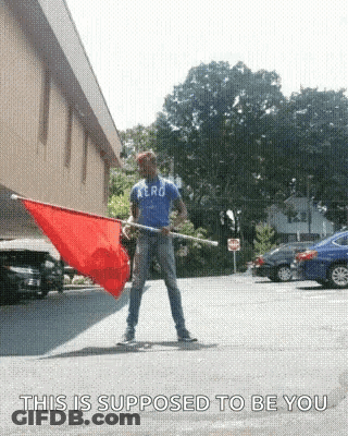 Man In Aero Shirt Holding Red Flag GIF