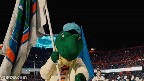 Man In Aggies Shirt In Front Of Scoreboard During Football Game GIF