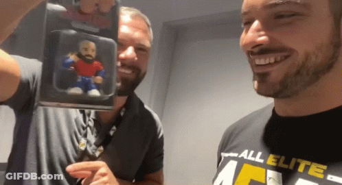 Man In All Elite Shirt Holding Toy GIF