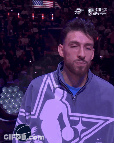 Man In All Star Jacket In Front Of Screen GIF