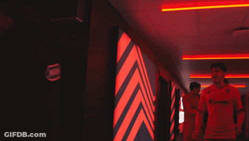 Man In Allianz Jersey Walking Down Hallway GIF