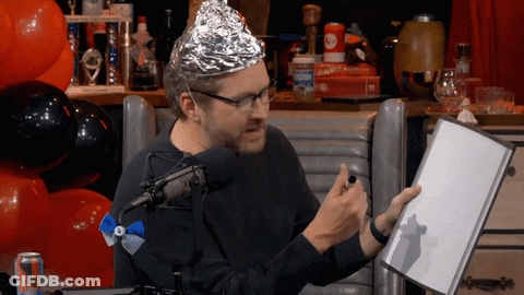 Man In Aluminum Foil Hat Holding Book GIF