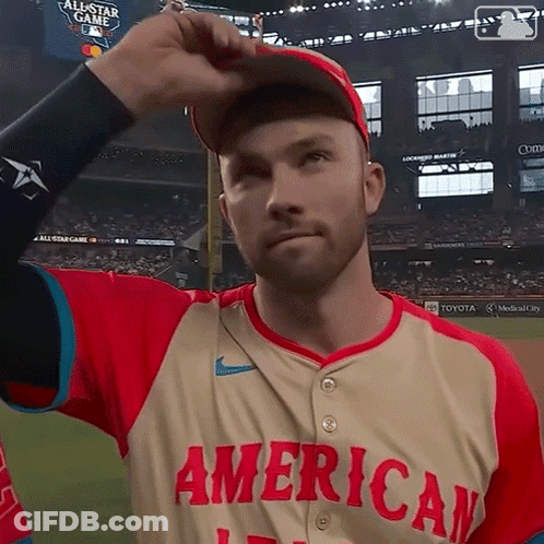 Man In American Baseball Jersey Adjusts Cap GIF