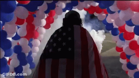 Man In American Flag Cape With Red White Blue Balloons GIF