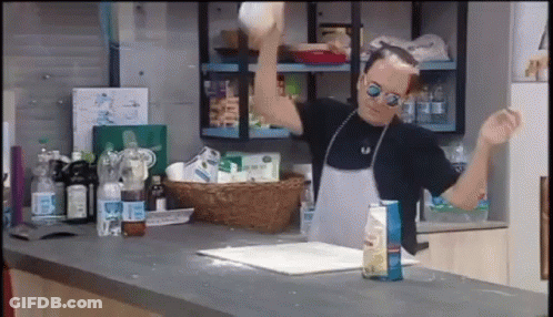 Man In Apron And Sunglasses Throwing A Ball GIF