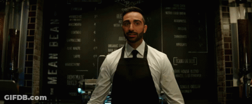 Man In Apron At Mean Bean Menu GIF