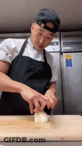 Man In Apron Cutting Onion GIF