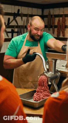 Man In Apron Grinding Meat GIF