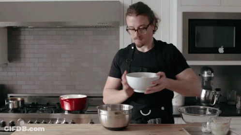 Man In Apron Holding Bowl GIF