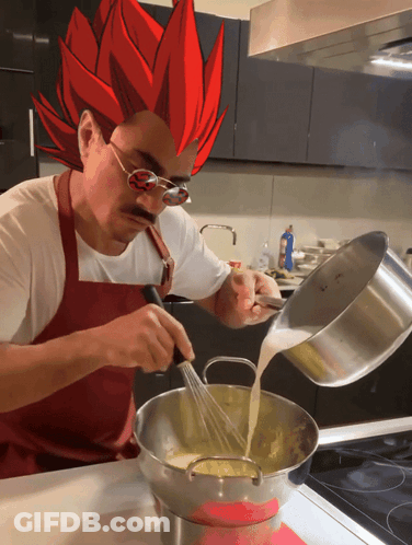 Man In Apron Pouring Liquid Into Pan GIF