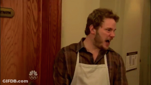 Man In Apron Standing Before Men Door GIF