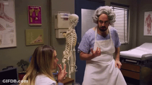 Man In Apron Standing In Front Of Skeleton GIF