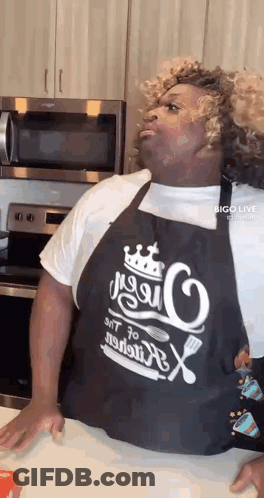 Man In Apron Standing In Kitchen GIF