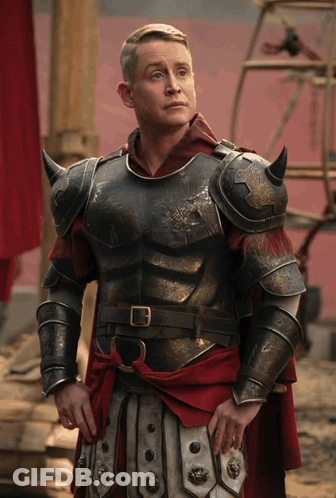 Man In Armor And Red Cape By Red Wall GIF
