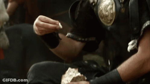 Man In Armor Eating Bread GIF