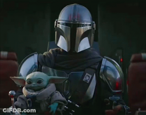 Man In Armor Holding Baby Yoda GIF
