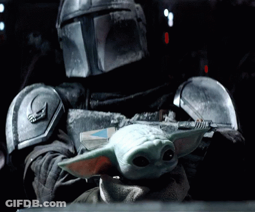 Man In Armor Holding Baby Yoda GIF