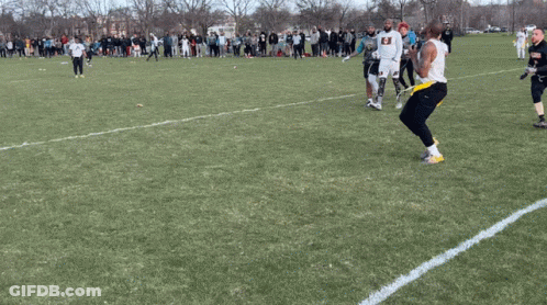 Man In Armor Holding Shield And Axe On Sidewalk GIF
