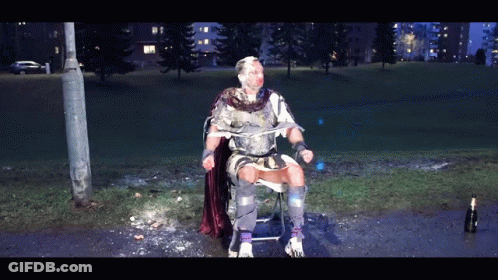 Man In Armor Sitting With Ice-Covered Face GIF