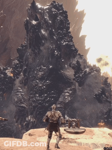 Man In Armor Standing Before Large Rock Formation GIF