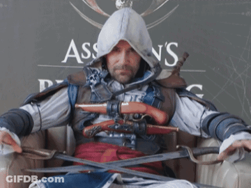 Man In Assassin's Creed Costume Holding Swords GIF