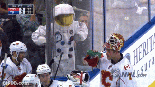 Man In Astronaut Costume Drinking Green Bottle GIF