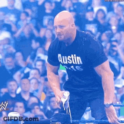 Man In Austin Shirt Kneeling Down GIF