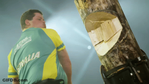 Man In Australia Shirt Next To Log GIF