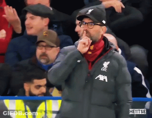 Man In AXA Jacket Shushing GIF