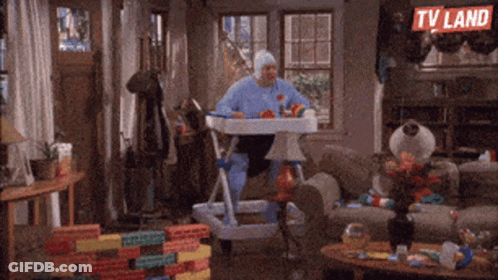 Man In Baby Costume Sitting In High Chair GIF