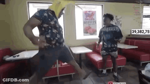 Man In Banana Hat Dancing In Diner GIF