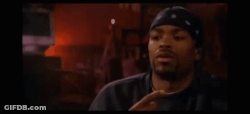 Man In Bandana And Hat Sitting At Candlelit Table GIF
