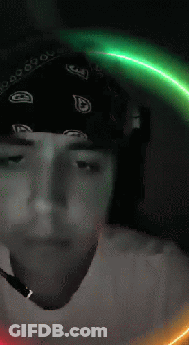 Man In Bandana And Headphones Looking At Camera GIF