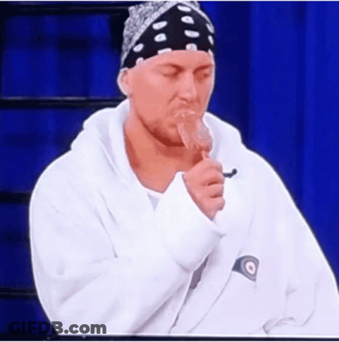 Man In Bandana And White Sweatshirt Eating Popsicle GIF