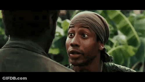 Man In Bandana Talking To Another In Forest GIF