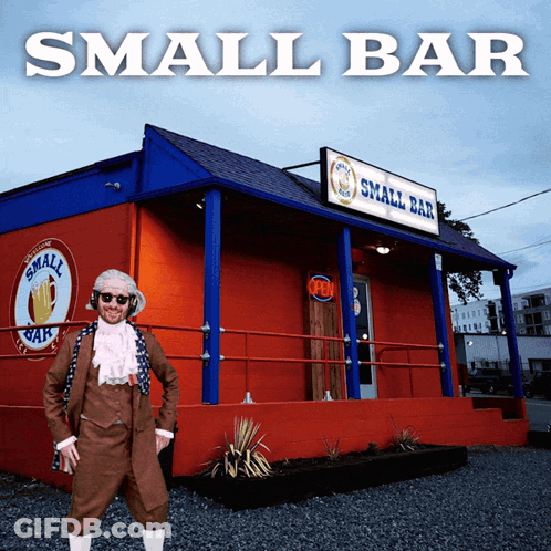 Man In Bar Costume In Front Of Red Building GIF